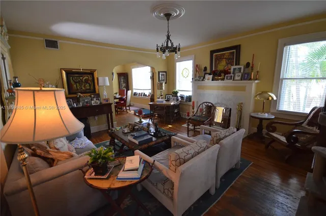 a living room with furniture and a chandelier