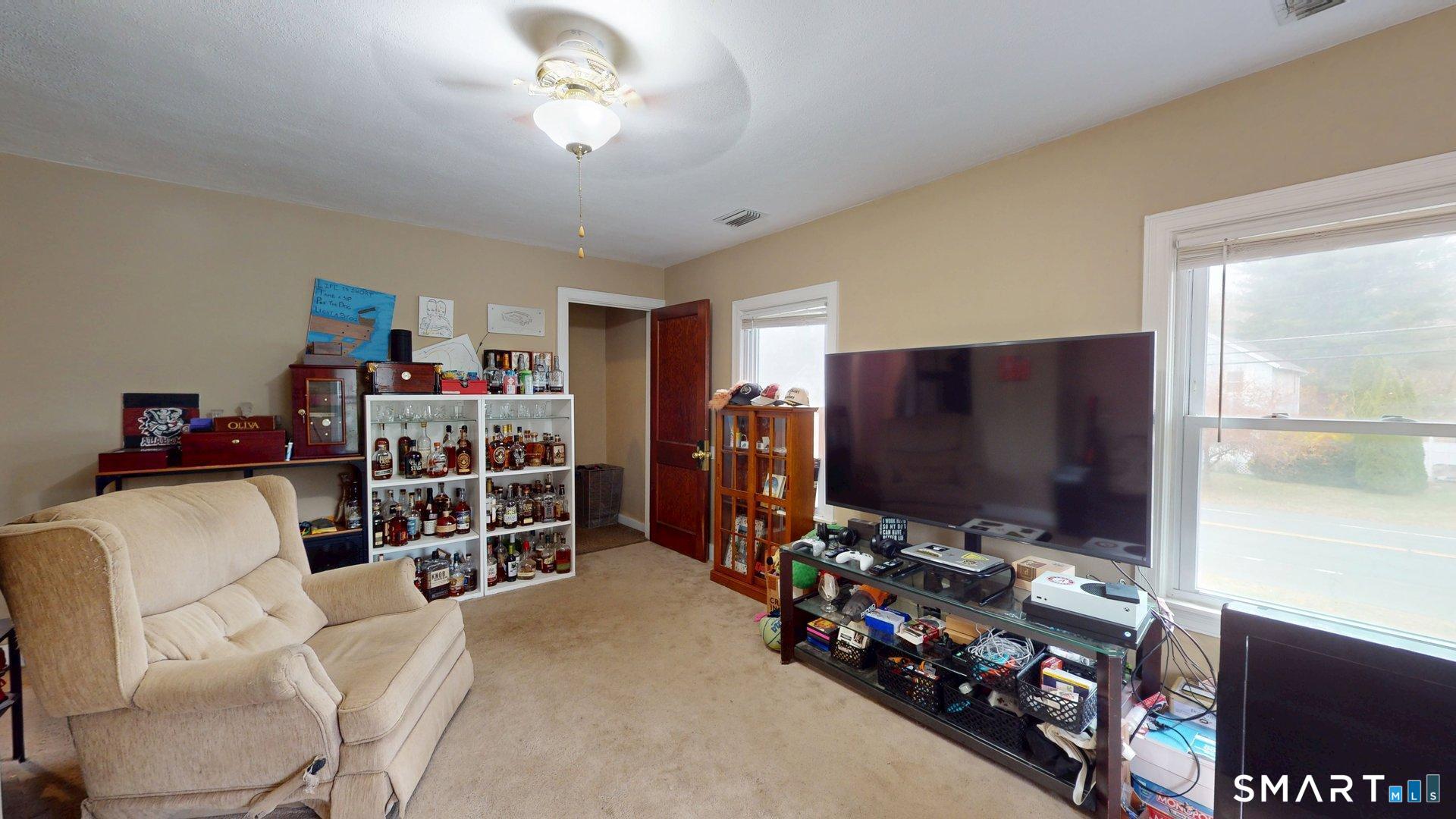 138 Main Street Somers, CT 06071 - Photo 16 of 38 a living room with furniture and a flat screen tv