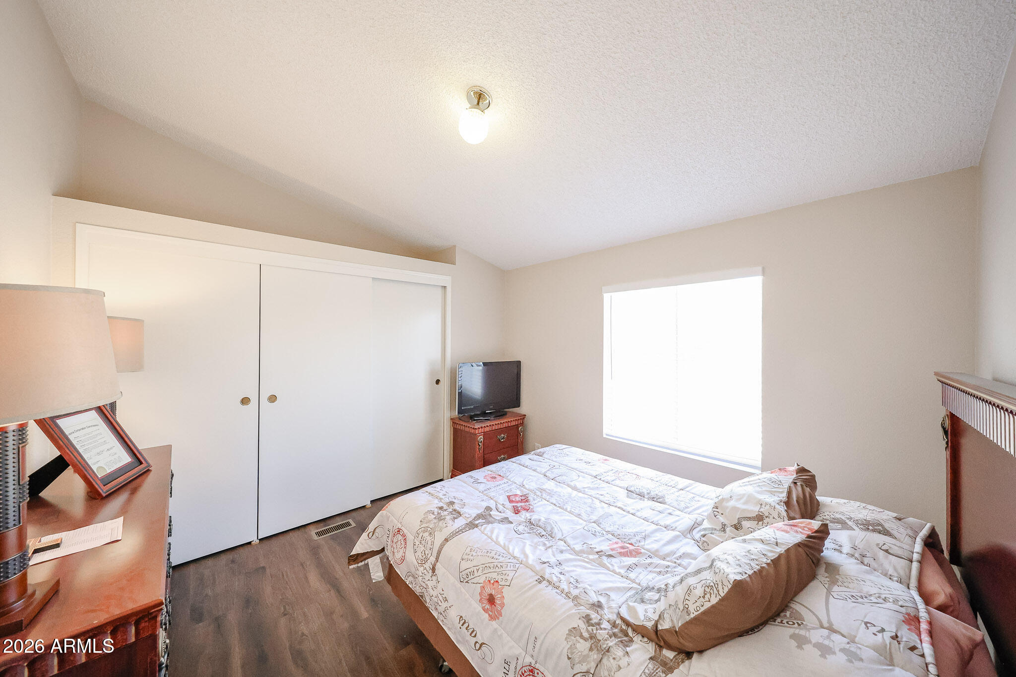 3901 East Pinnacle Peak Road, Unit 355 Phoenix, AZ 85050 - Photo 13 of 29 a bed sitting in a bedroom next to a window