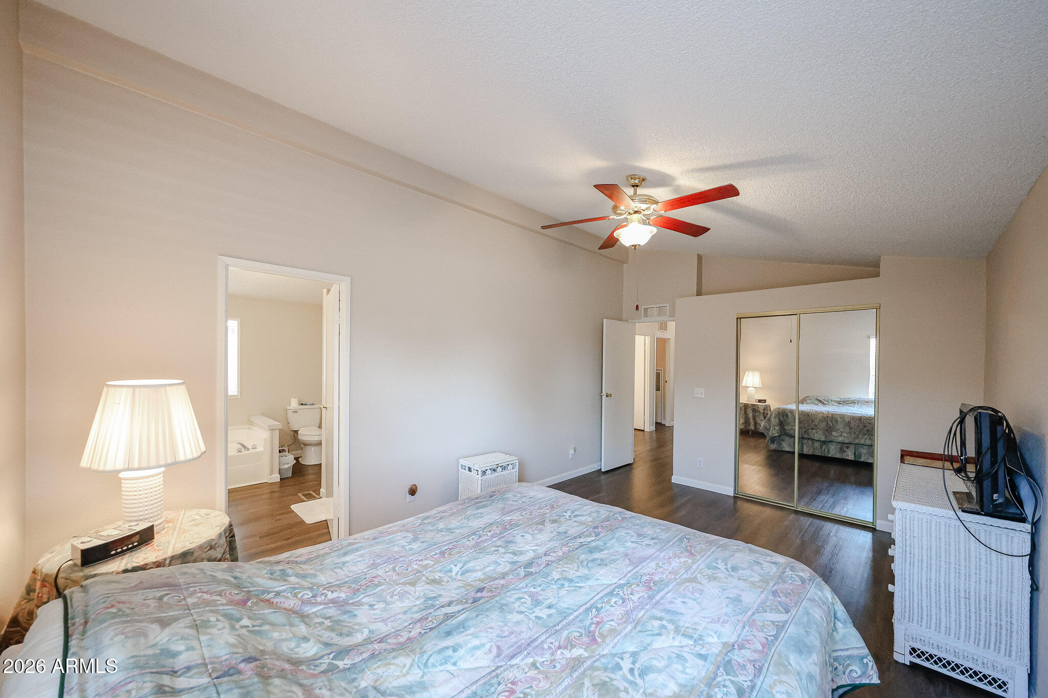 3901 East Pinnacle Peak Road, Unit 355 Phoenix, AZ 85050 - Photo 16 of 29 a bedroom with a bed and a chandelier