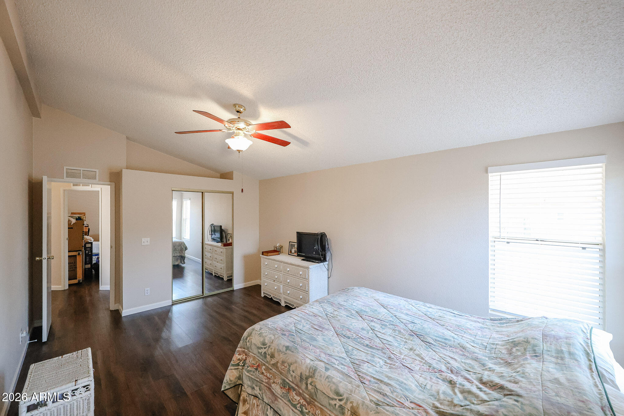3901 East Pinnacle Peak Road, Unit 355 Phoenix, AZ 85050 - Photo 17 of 29 a bed room with a bed and a chandelier