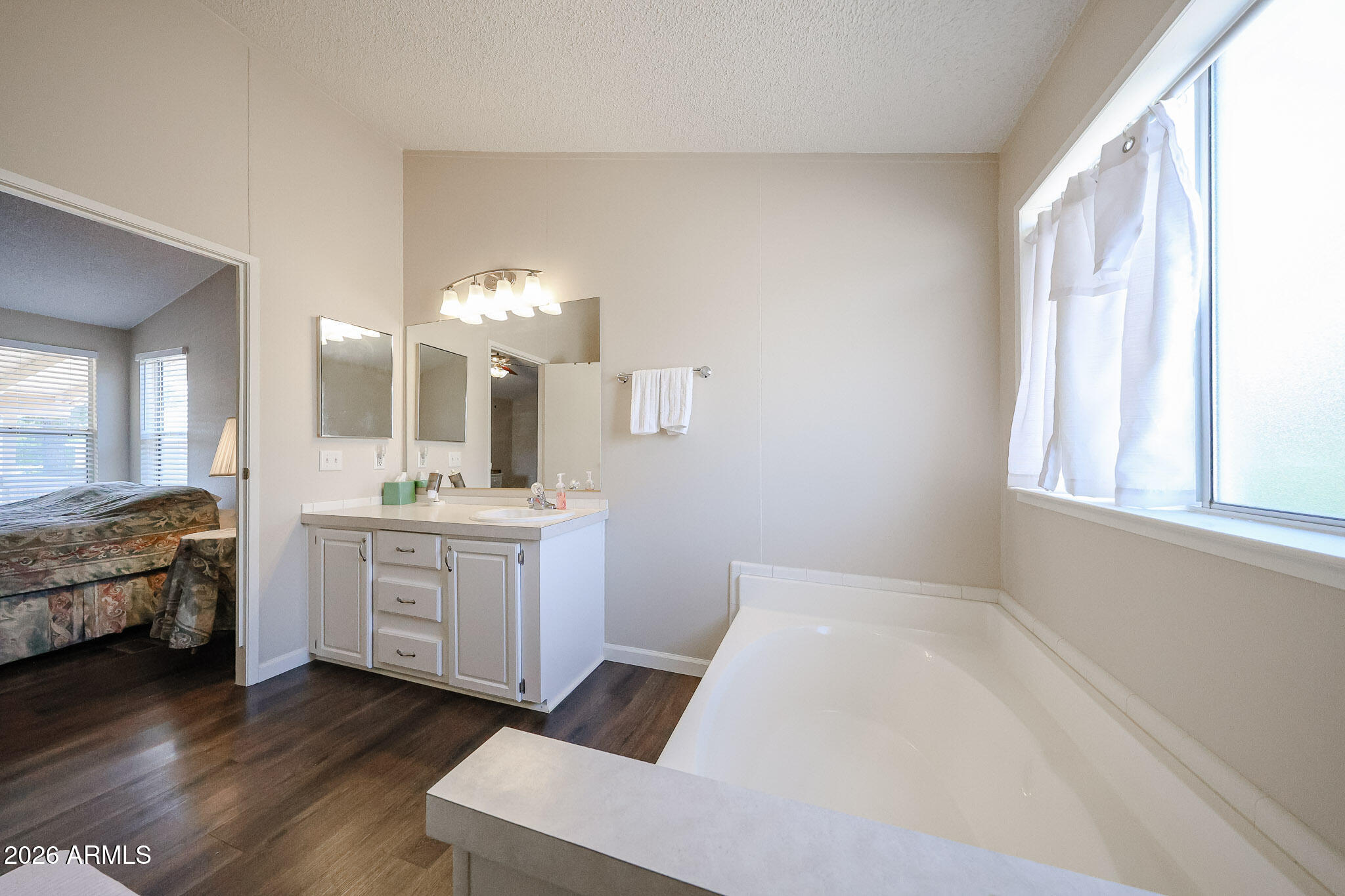 3901 East Pinnacle Peak Road, Unit 355 Phoenix, AZ 85050 - Photo 21 of 29 a room with a bed and a mirror
