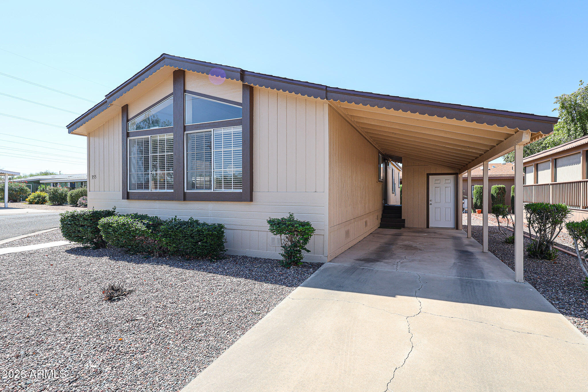 3901 East Pinnacle Peak Road, Unit 355 Phoenix, AZ 85050 - Photo 25 of 29 a front view of a house with garden