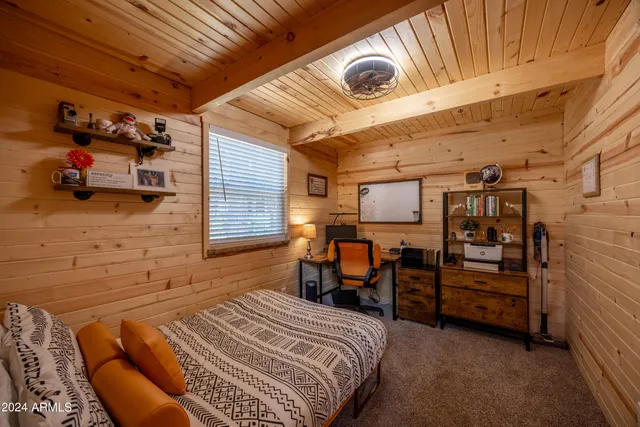 a bed sitting in a bedroom next to a window
