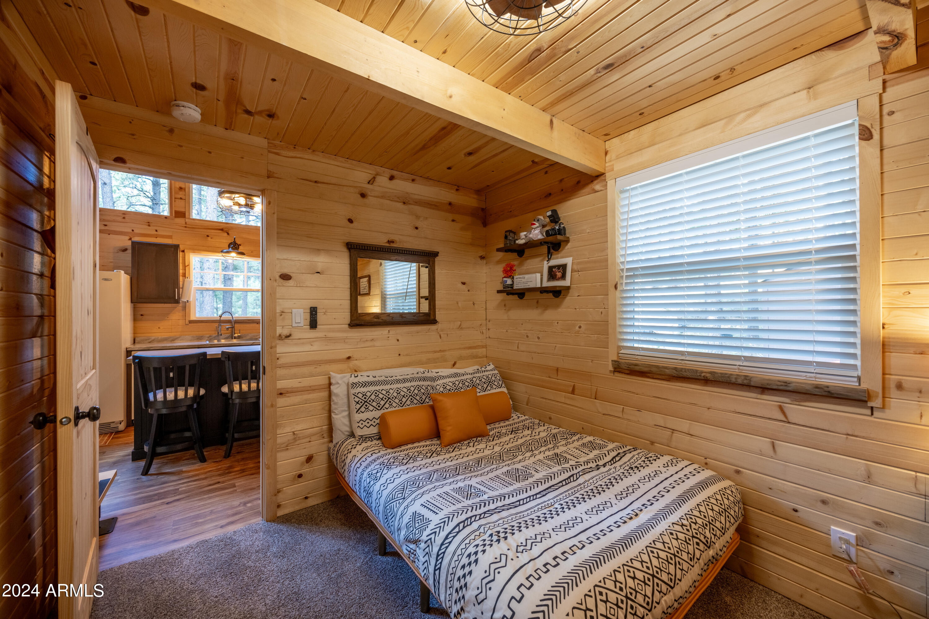 1225 Highway Loop Forest Lakes, AZ 85931 - Photo 19 of 45 a bedroom with a bed and wooden floor