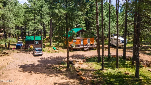 a view of a backyard with wooden fence