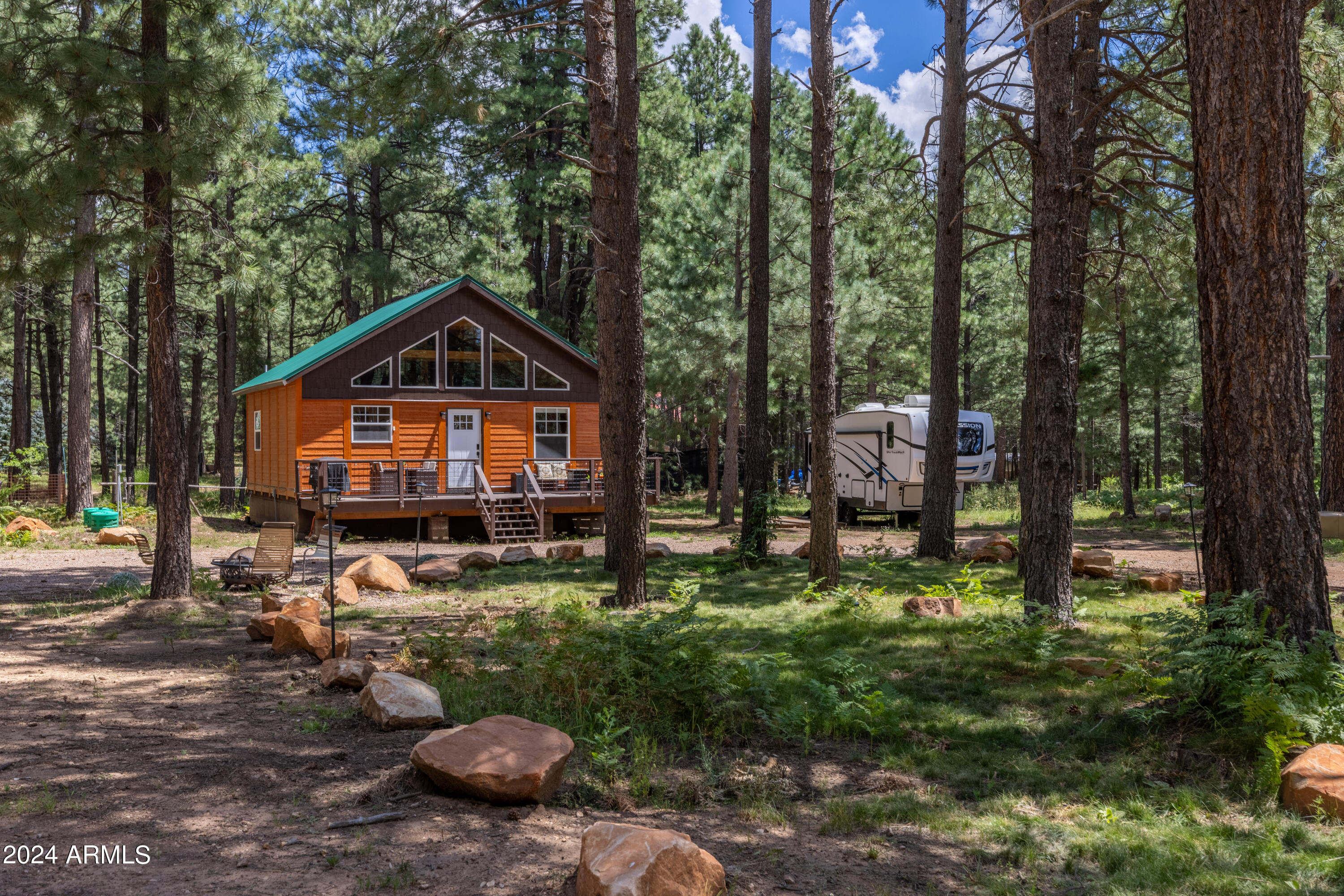 1225 Highway Loop Forest Lakes, AZ 85931 - Photo 4 of 45 a front view of a house with a yard