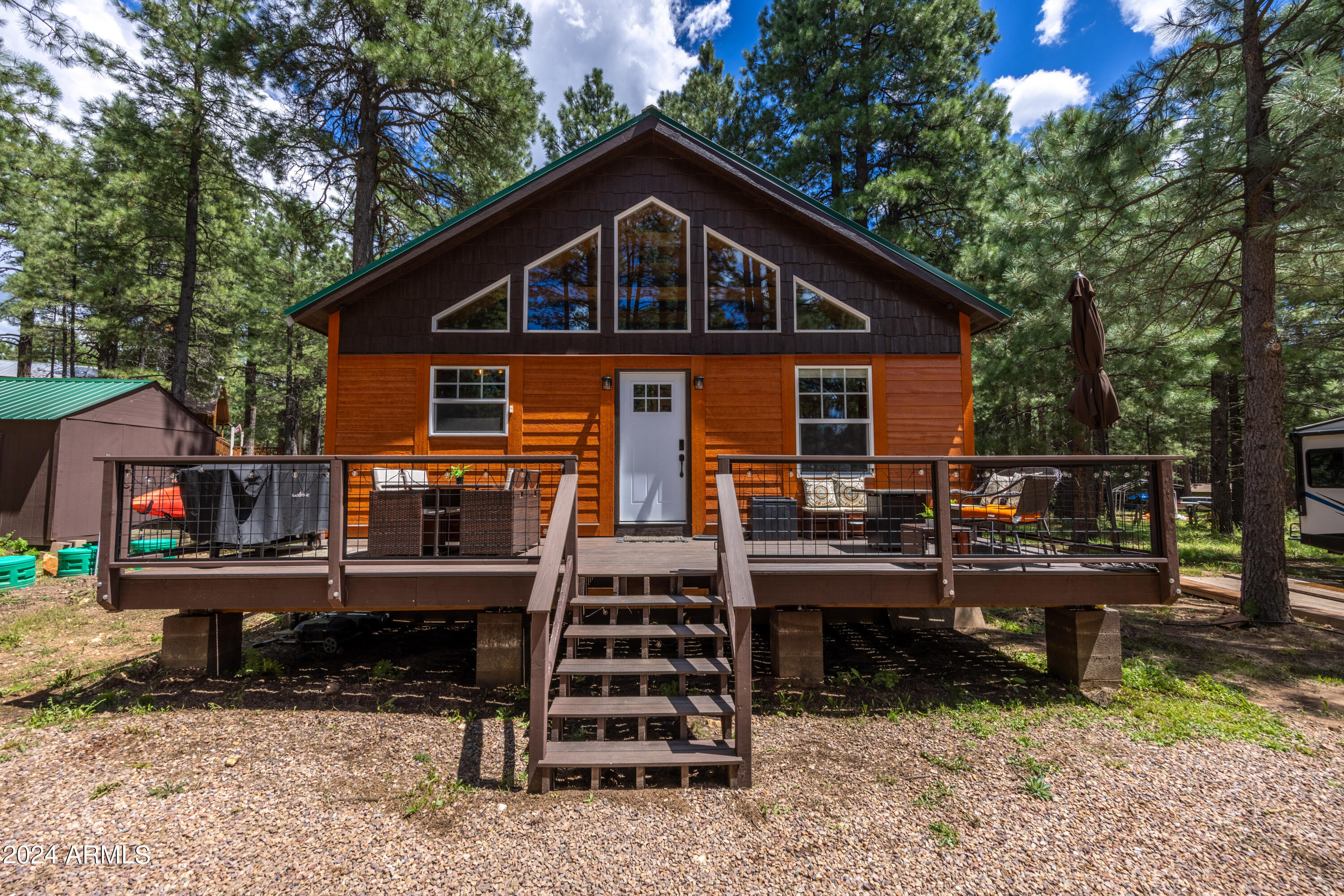 1225 Highway Loop Forest Lakes, AZ 85931 - Photo 7 of 45 a front view of a house with wooden deck and trees