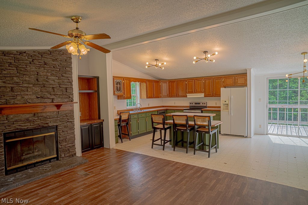 967 Buck Run Road Mineral Wells, WV 26150 - Photo 17 of 50 Open concept living area featuring a stone-clad fireplace with wood mantel, built-in shelving, and wood-finish flooring