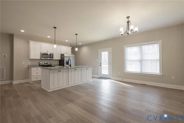 a view of kitchen with sink microwave and refrigerator