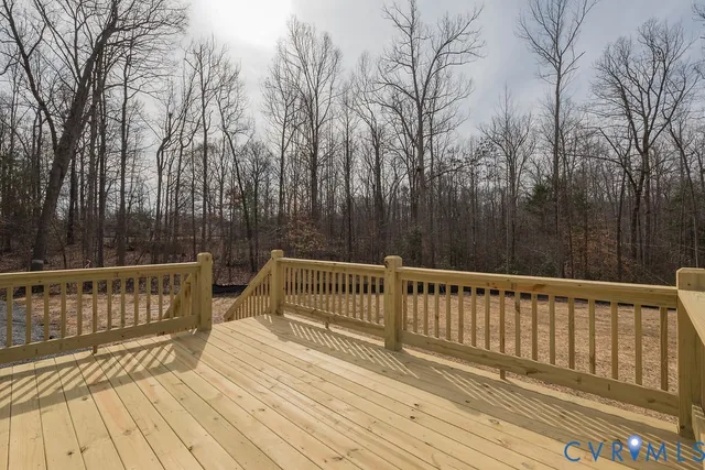a view of deck with trees and wooden floor and fence