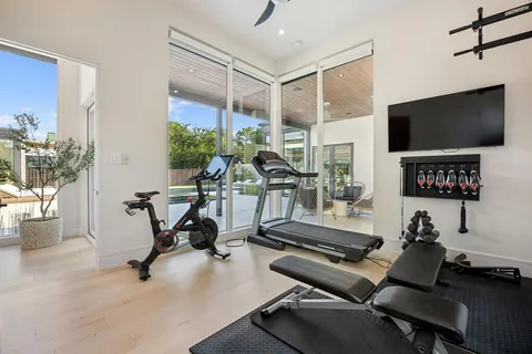 a room with gym equipment and a flat screen tv