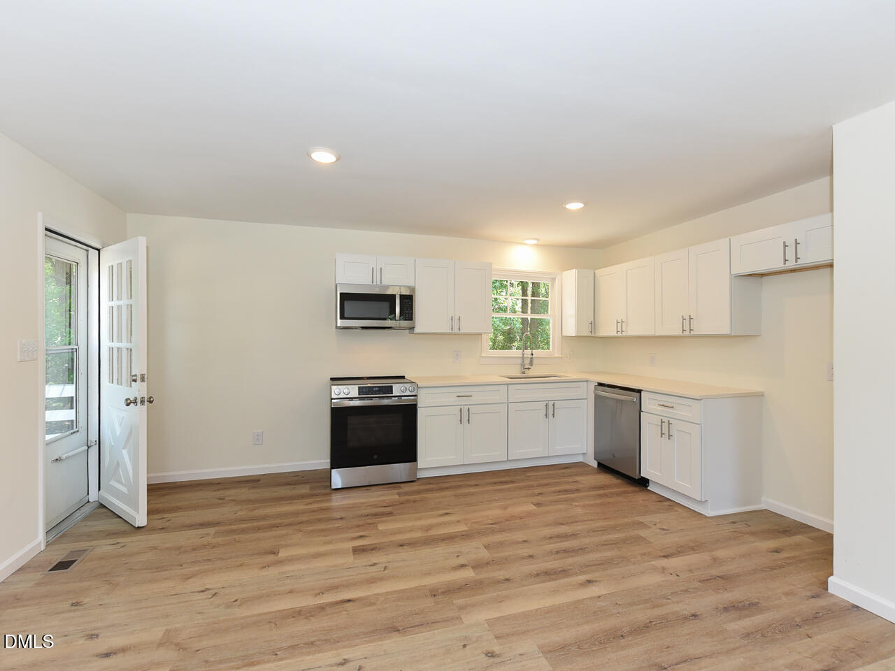 939 Cheves Road Zebulon, NC 27597 - Photo 6 of 21 a large kitchen with stainless steel appliances granite countertop a stove and a refrigerator