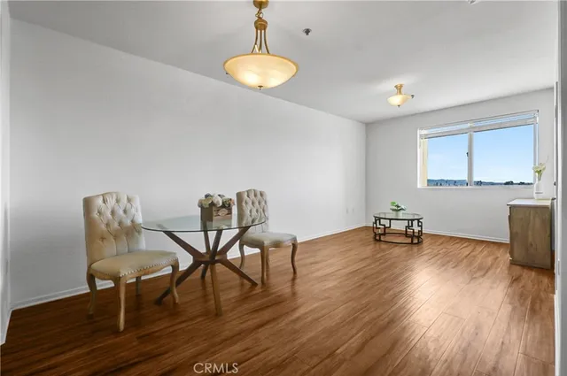 a view of a room with furniture and wooden floor