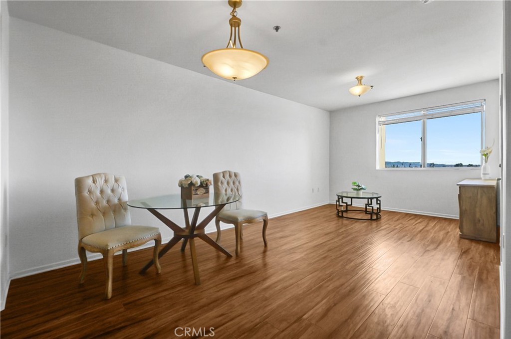 580 West Main Street, Unit 318 Alhambra, CA 91801 - Photo 12 of 33 a view of a room with furniture and wooden floor
