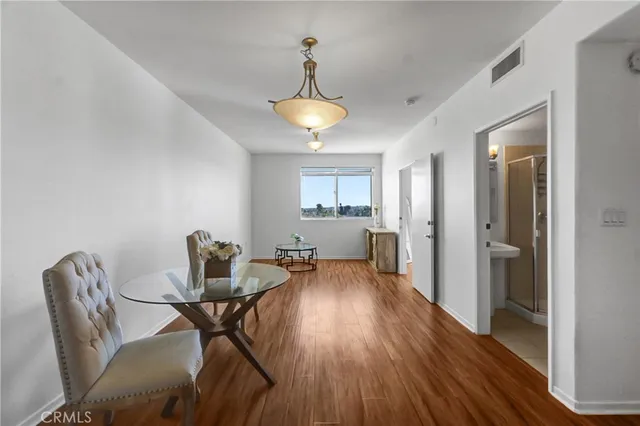 a view of a dining room with furniture and wooden floor