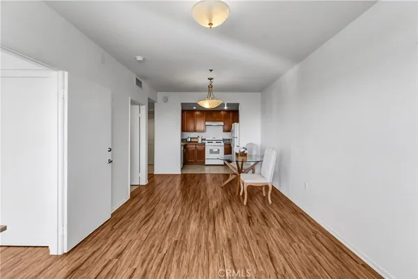 a view of a room with wooden floor furniture and windows