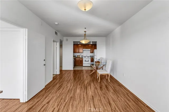 a view of a room with wooden floor furniture and windows