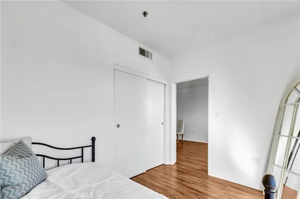 a view of a room with wooden floor and bedroom