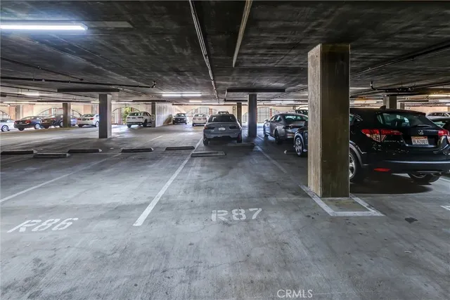 a view of parking garage with cars