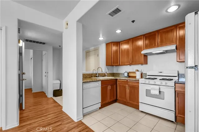 a kitchen with stainless steel appliances granite countertop a stove and a refrigerator