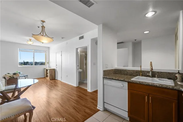 a spacious bathroom with a granite countertop sink a mirror and shower
