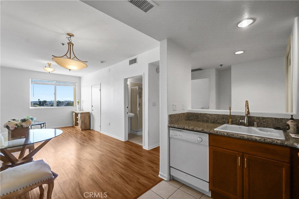 580 West Main Street, Unit 318 Alhambra, CA 91801 - Photo 10 of 33 a spacious bathroom with a granite countertop sink a mirror and shower