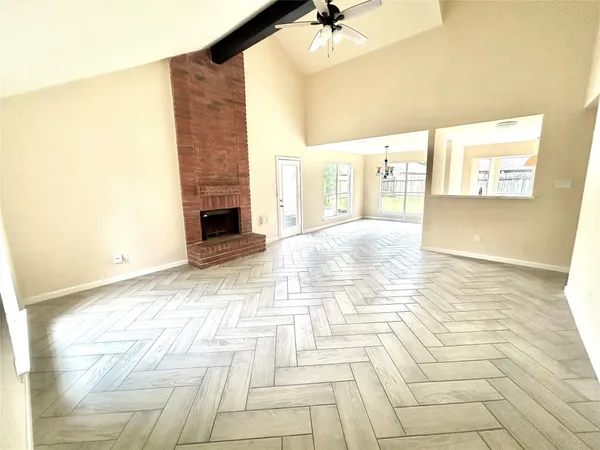 a view of empty room with a fireplace