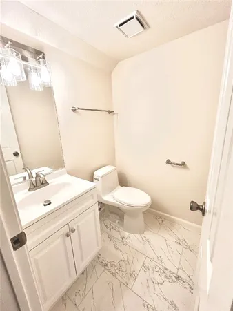 a bathroom with a sink a toilet and vanity