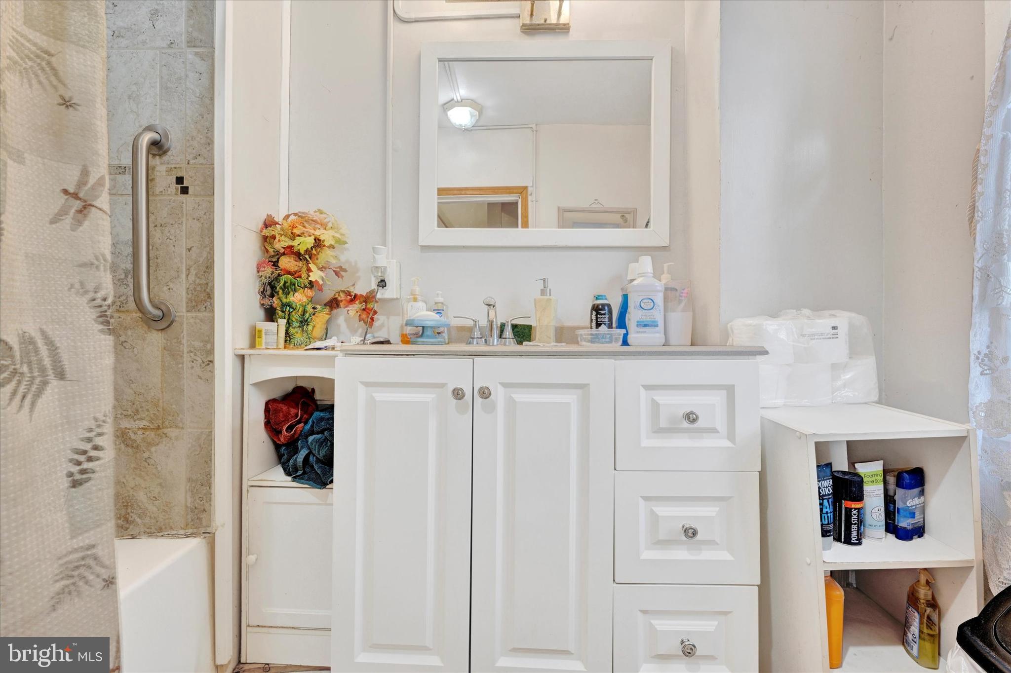 1220 West Pratt Street Baltimore, MD 21223 - Photo 11 of 14 a bathroom with a sink and a mirror