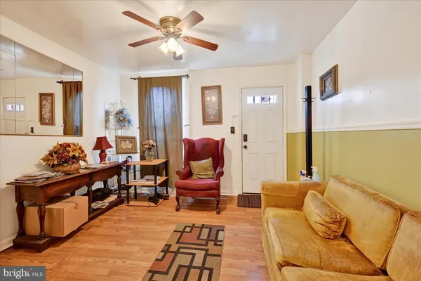 a living room with furniture a chandelier and a rug