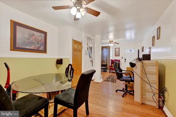 a view of a dining room with furniture and a chandelier
