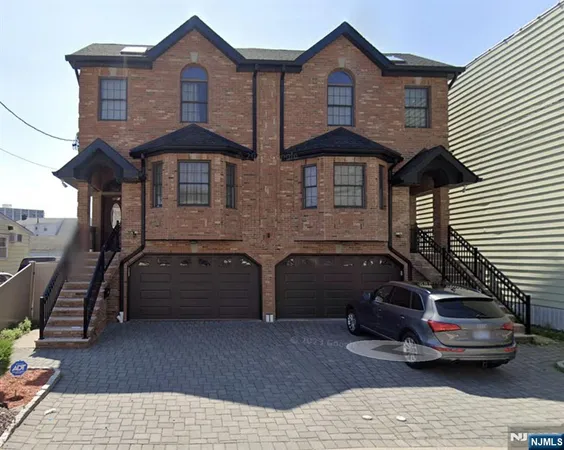 a front view of a house with parking space