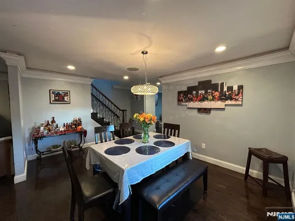 a view of a dining room and a kitchen with a table chairs