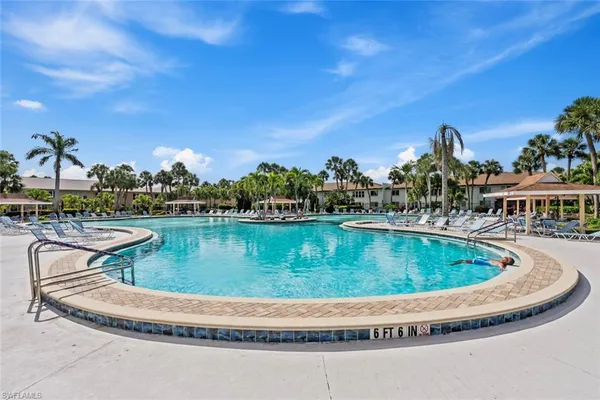 a view of a swimming pool with a table and chairs