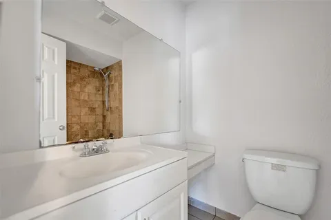a bathroom with a toilet sink and shower