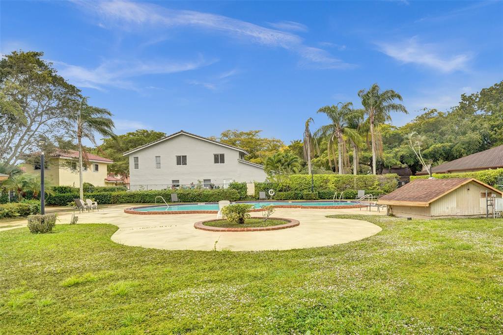26 Wimbledon Lakes Drive, Unit 248 Plantation, FL 33324 - Photo 20 of 26 a view of a house with swimming pool and a yard