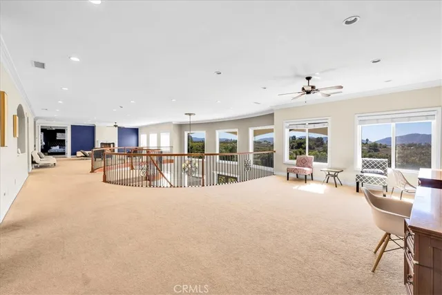 a living room with fireplace furniture and a large window