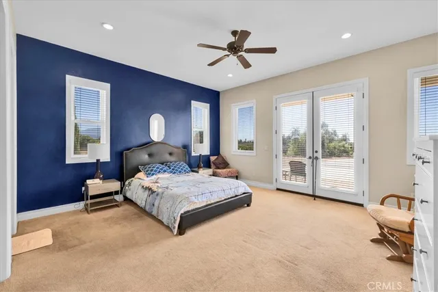 a spacious bedroom with a large bed and a tv