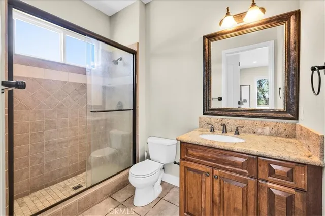 a spacious bedroom with a bed and a fireplace