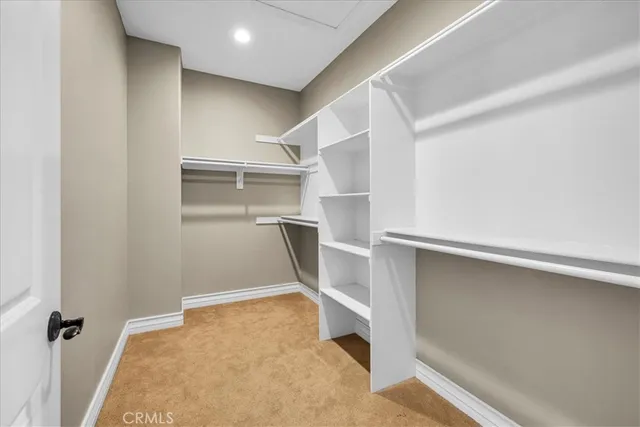 a spacious bedroom with a large bed and a large window