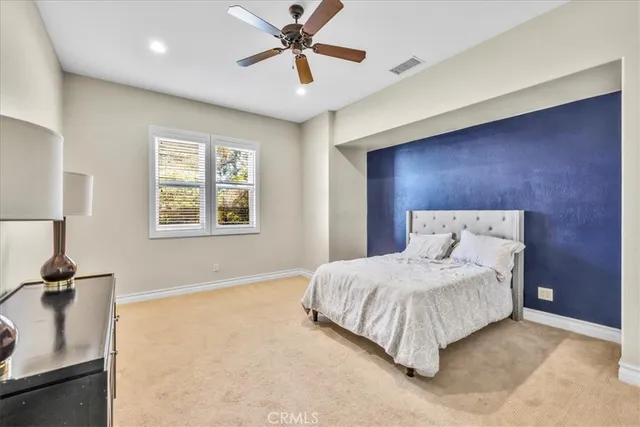 a bedroom with furniture and a chandelier