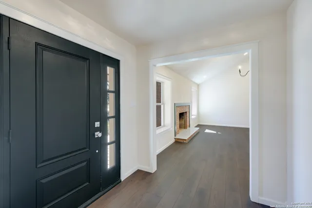wooden floor with a kitchen