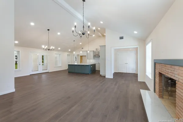 a view of a kitchen with a sink and a fireplace