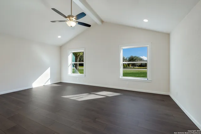 a spacious bathroom with a double vanity sink and mirror