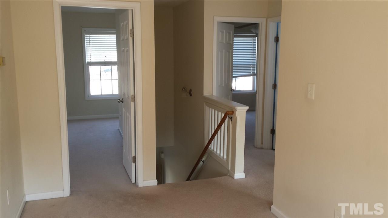 6912 Missionary Ridge Drive Raleigh, NC 27610 - Photo 13 of 16 a view of a hallway with wooden floor and entryway