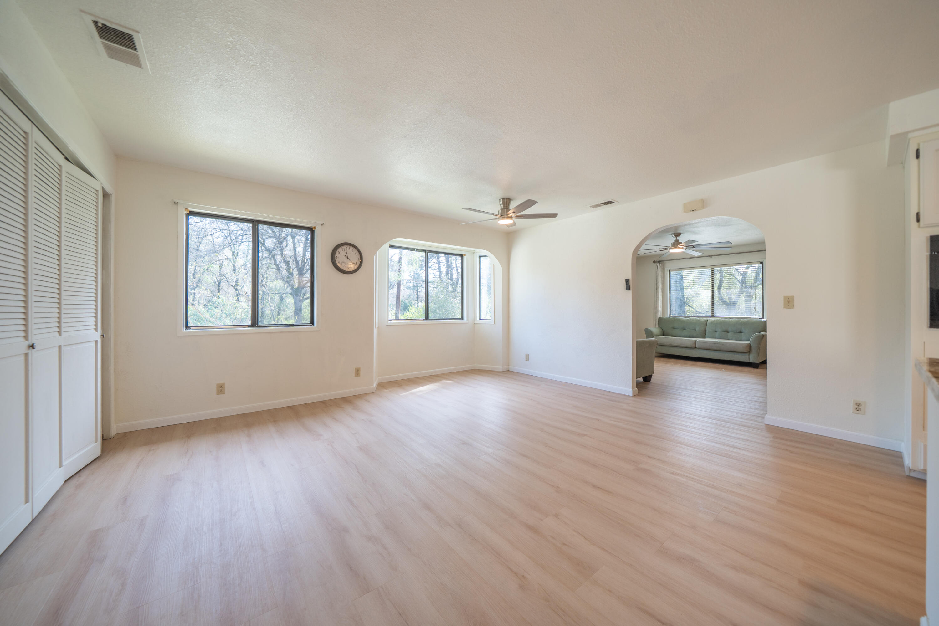 2580 Keswick Dam Road Redding, CA 96003 - Photo 10 of 60 an empty room with wooden floor and windows