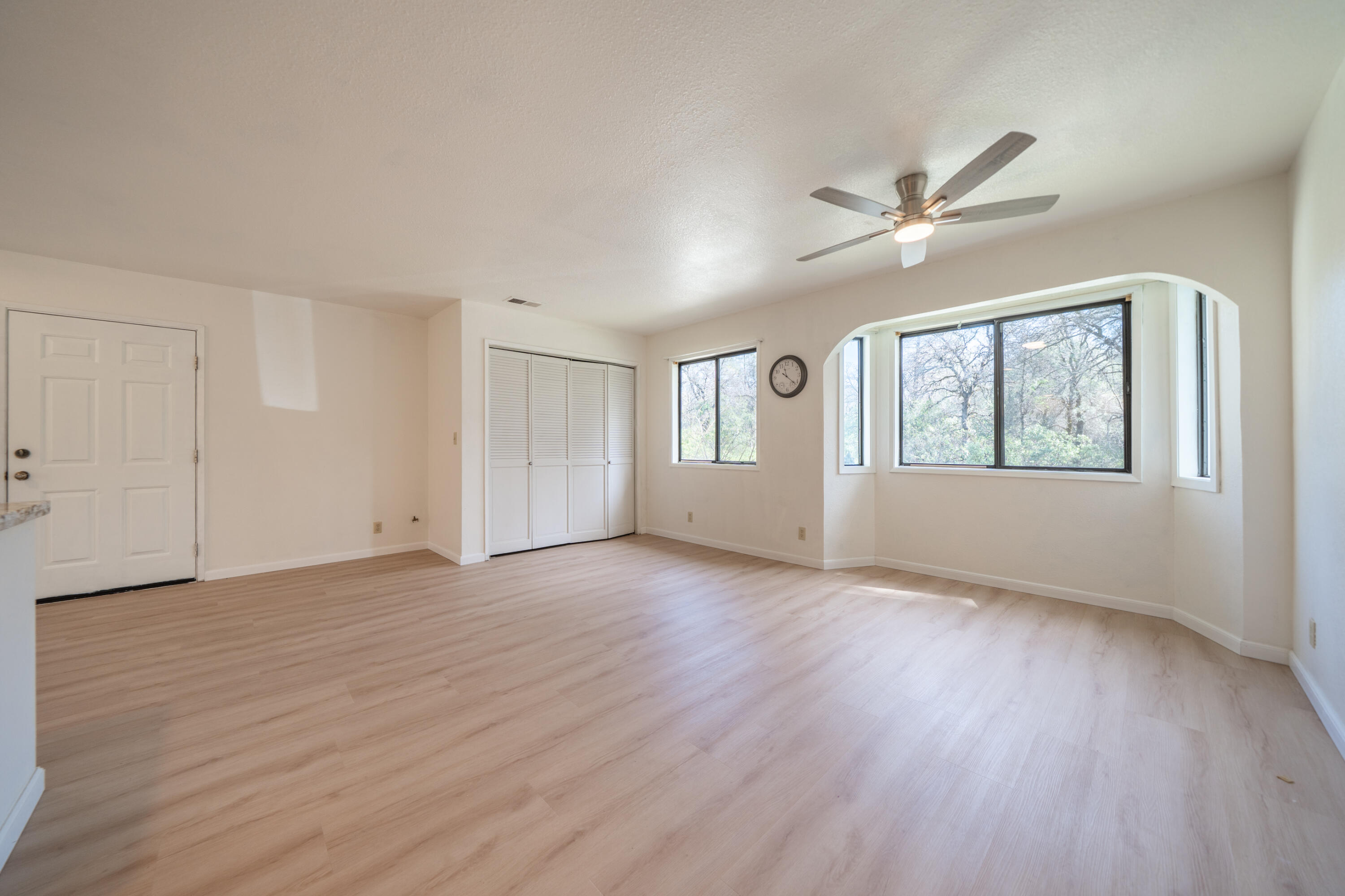 2580 Keswick Dam Road Redding, CA 96003 - Photo 11 of 60 a view of an empty room with a window and wooden floor