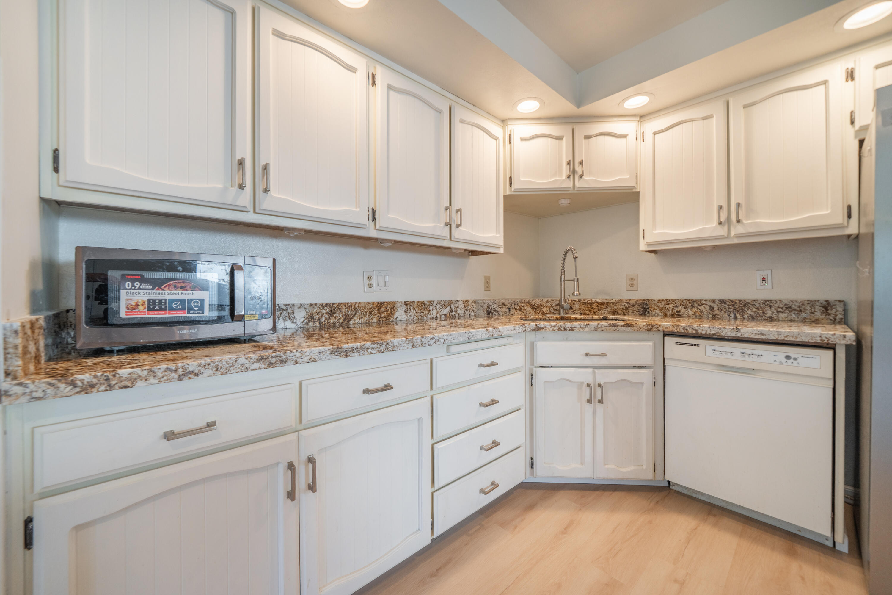 2580 Keswick Dam Road Redding, CA 96003 - Photo 15 of 60 a kitchen with granite countertop white cabinets and sink