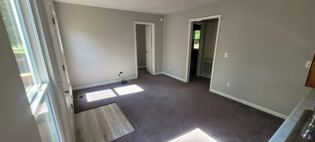an entryway with wooden floor and a window